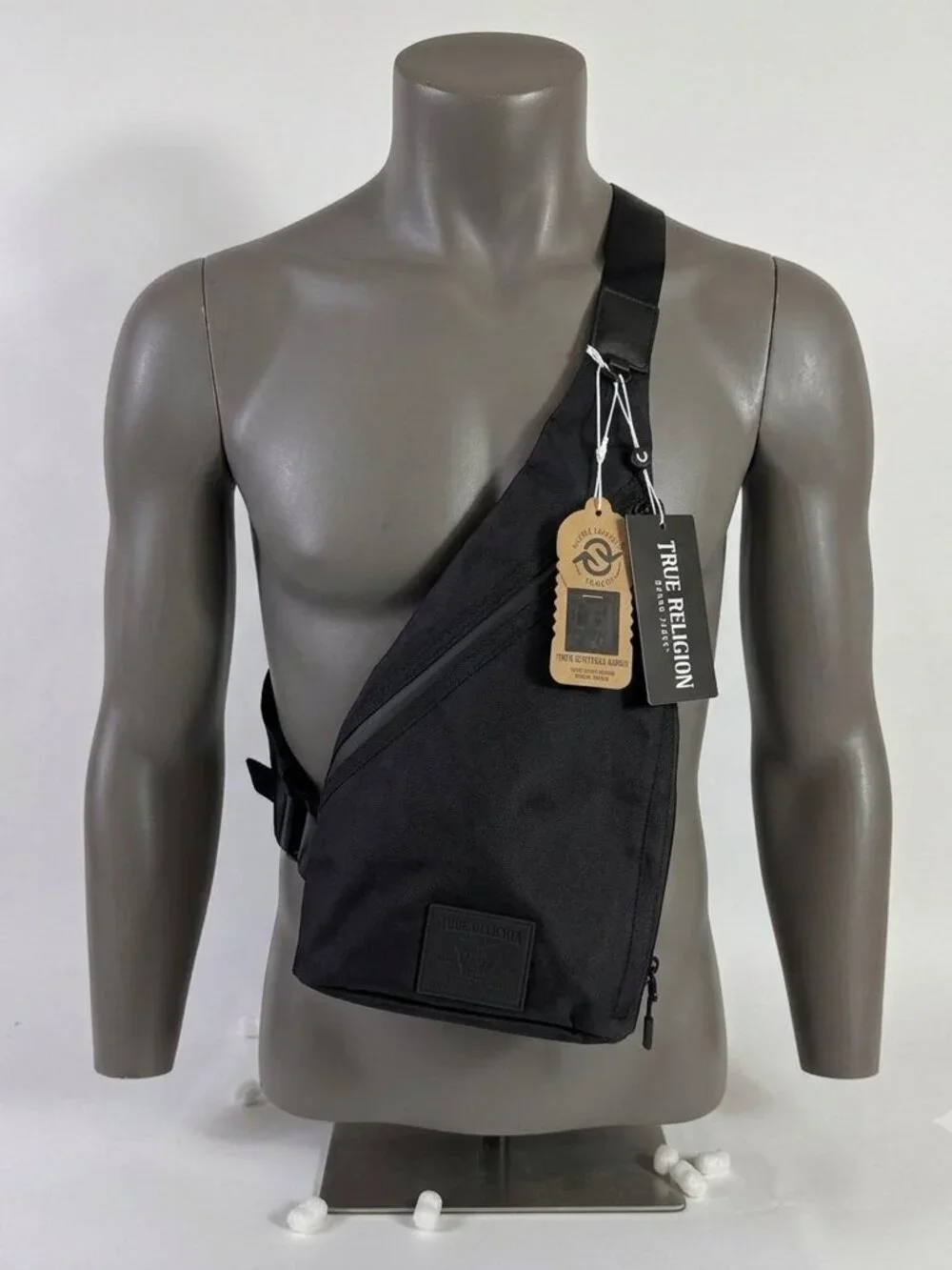True Religion Black Sling Bag Features a Textured Black Logo Patch on the Front